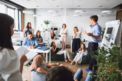 A diverse team engages in a productive meeting in a modern office setting with open communication.