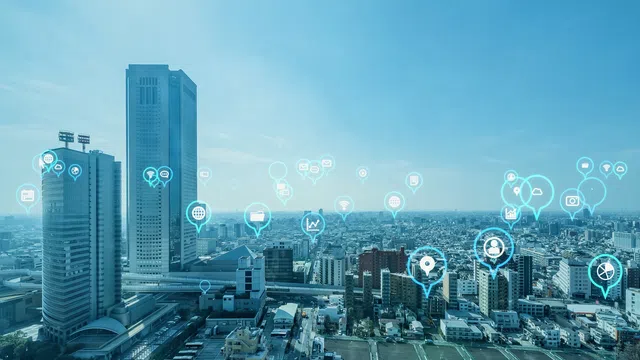 City skyline with digital icons representing technology and connectivity in urban life.