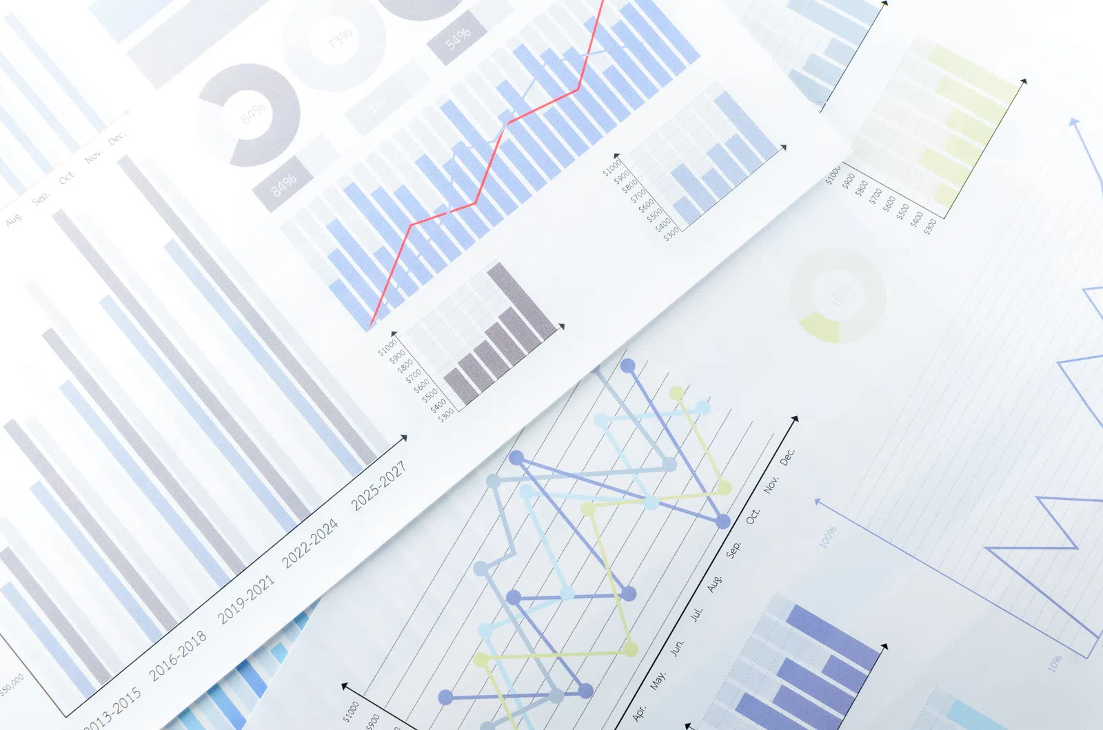 Various graphs and charts displaying data trends and statistics on paper sheets.