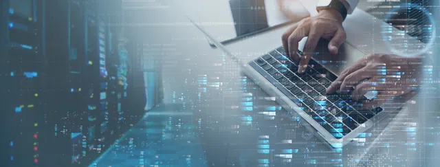 Person typing on a laptop with data visualizations in the background.
