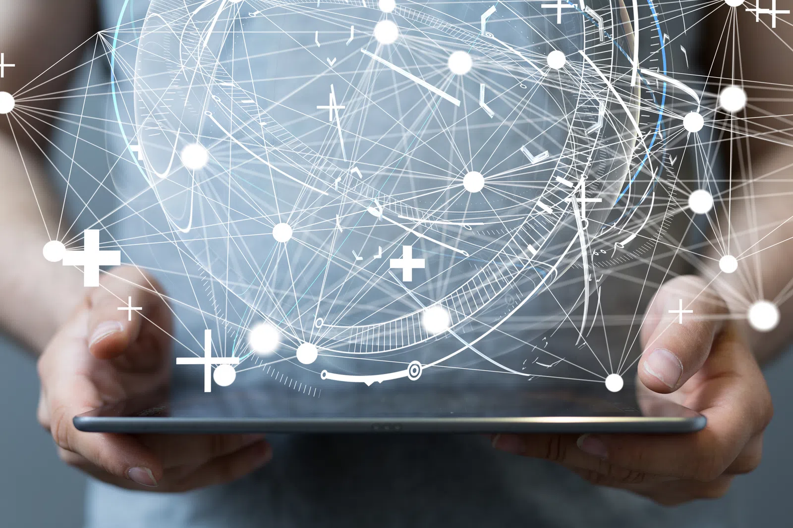 Person holding tablet with abstract digital connections and data visualization above it.
